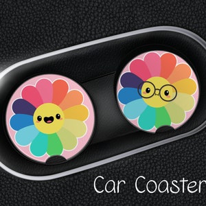May include: Two colorful car coasters with a rainbow flower design. One flower has a smiling face and the other has a smiling face with glasses. The text "Car Coasters" is printed below the coasters.