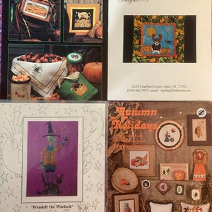 May include: A collection of Halloween and autumn-themed cross-stitch patterns. The image features various designs, including pumpkins, witches, and seasonal motifs. The text "Happy Halloween" and "Autumn Holidays" are visible.
