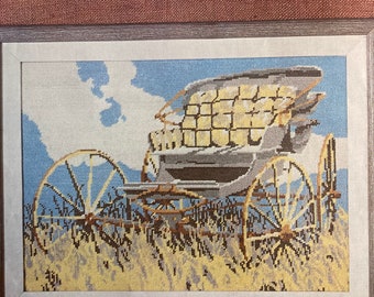 May include: A needlepoint pattern for a carriage with a blue sky and yellow field background. The pattern is titled "Carriage" and is 18 x 14 inches.