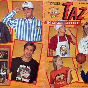 May include: A collection of cross stitch patterns featuring Taz, the Tasmanian Devil from the Looney Tunes cartoon. The patterns include Taz in various poses, including wearing a graduation cap and gown, a baseball cap, and a shirt that says "Bad to the Bone".