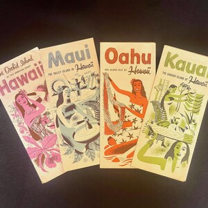 May include: Four vintage-style travel brochures for Hawaii islands. The first features pink Hawaii text and orchids. The second shows Maui with a person preparing poi. The third displays Oahu with a lei-wearing figure. The fourth depicts Kauai with green foliage.