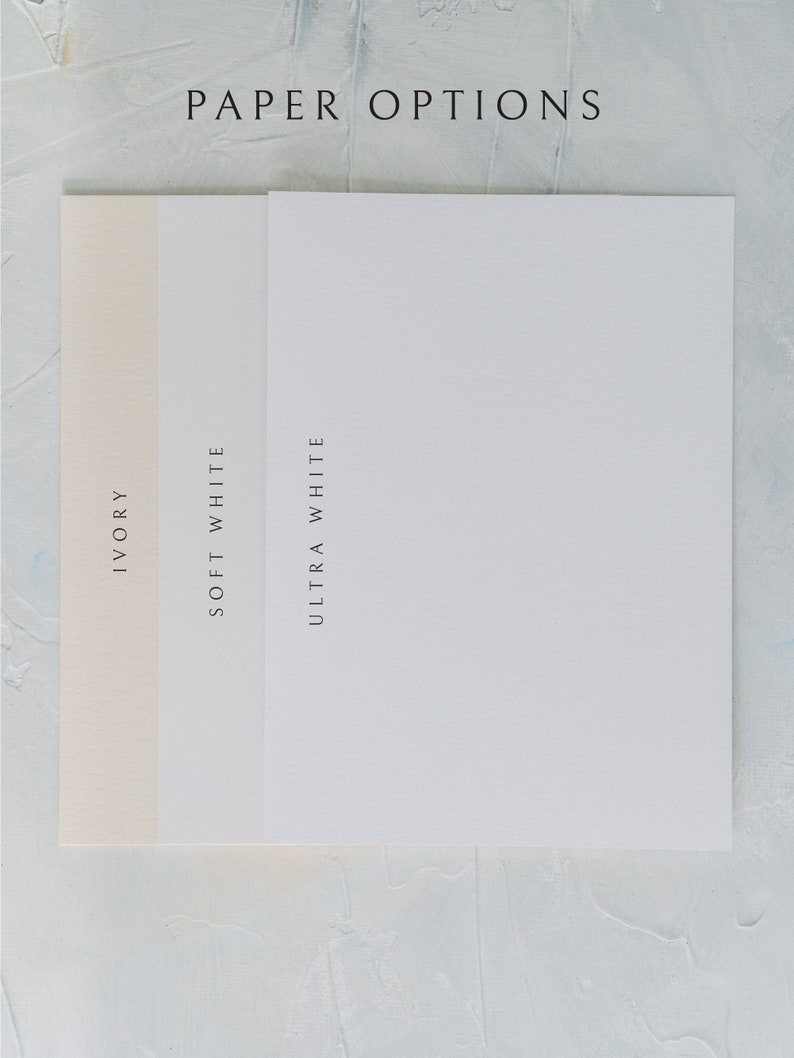 May include: Three paper samples in ivory, soft white, and ultra white. The paper is smooth and has a subtle texture.  PAPER OPTIONS is written at the top of the image.