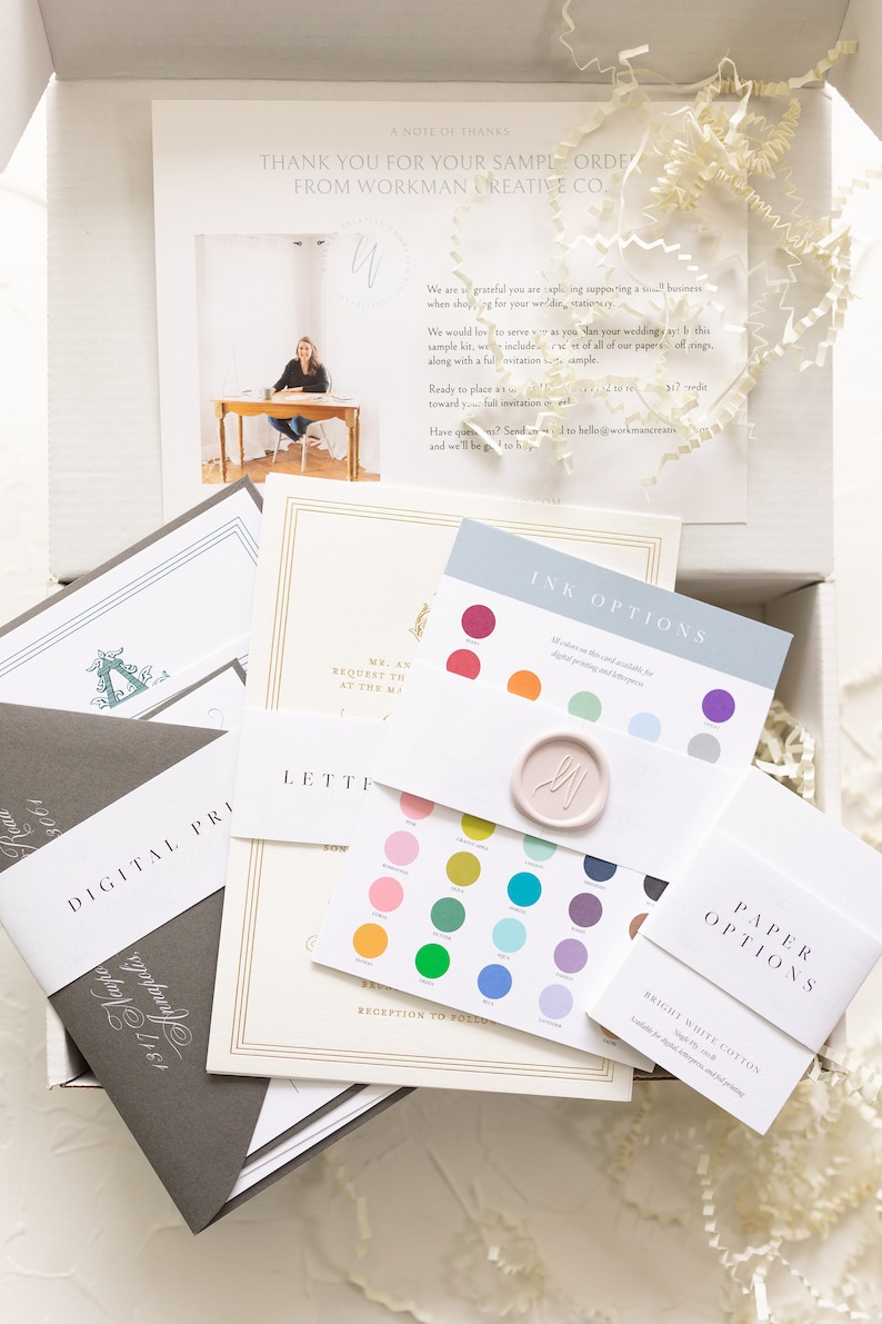 May include: A sample wedding invitation kit with a variety of paper options, ink colors, and envelope styles. The kit includes a note from the company, "Workman Creative Co.", thanking the customer for their order.
