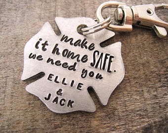 May include: Silver metal keychain shaped like a fire hydrant with the text "make it home safe. we need you. Ellie & Jack" engraved on it.