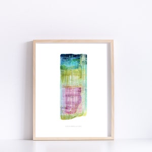 May include: A watercolor painting of a tourmaline crystal. The crystal is a vibrant mix of green, blue, pink, and yellow. The painting is framed in a light wood frame and has the word "Tourmaline" written below the crystal.