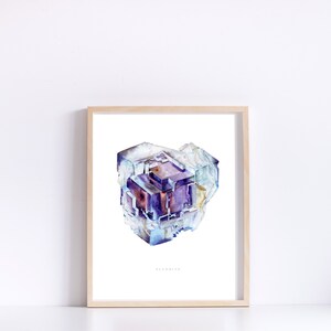 May include: A watercolor painting of a fluorite crystal. The crystal is a deep purple color with hints of blue and white. The painting is framed in a light wood frame and has the word "Fluorite" written below the crystal.