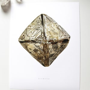 May include: A watercolor illustration of a diamond crystal on a white background. The diamond is a light brown color and has a geometric shape. The text "DIAMOND" is printed below the diamond.