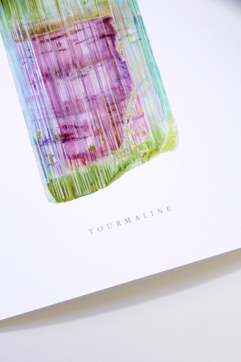 May include: A watercolor painting of a tourmaline crystal with green, purple, and blue hues. The word "TOURMALINE" is written in gray text below the crystal.