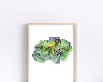 May include: A watercolor painting of a green, yellow, and purple fluorite crystal. The crystal is in a white frame with the word "Fluorite" printed below it.