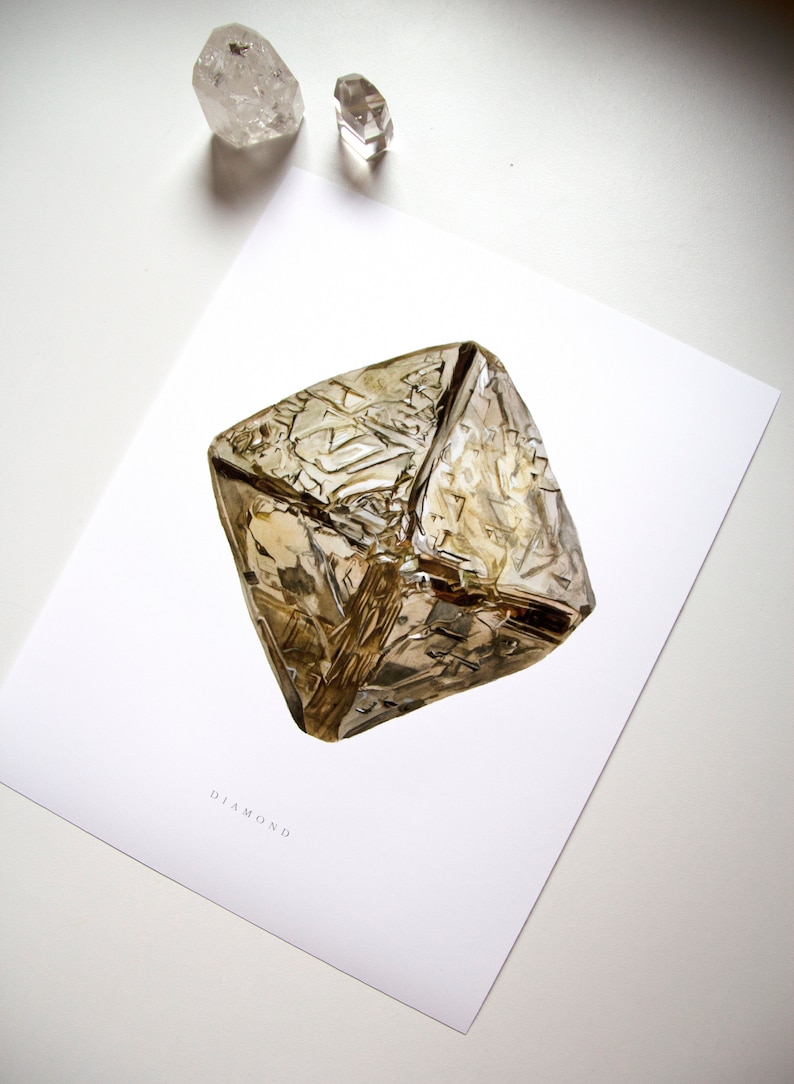 May include: A close-up of a large, clear, faceted diamond with a golden hue. The diamond is on a white background with the word "DIAMOND" printed below it.