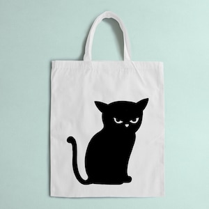 Könnte beinhalten: Eine weiße Einkaufstasche mit einer schwarzen Silhouette einer Katze mit einem wütenden Gesichtsausdruck.