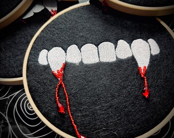 Bite me!  Embroidered vampire teeth hoop with hand beaded detailing.