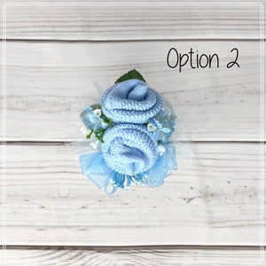 May include: A light blue baby sock flower bouquet with white tulle and blue ribbon. Option 2.