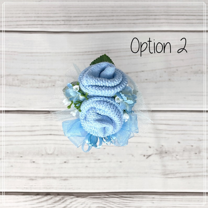 May include: A light blue baby sock flower bouquet with white tulle and blue ribbon. Option 2.