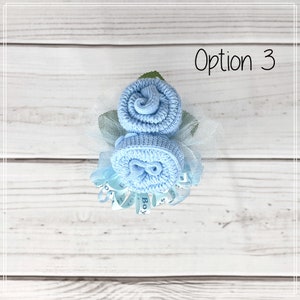 May include: A blue baby sock flower bouquet with a blue ribbon that says "It's a Boy!" Option 3.