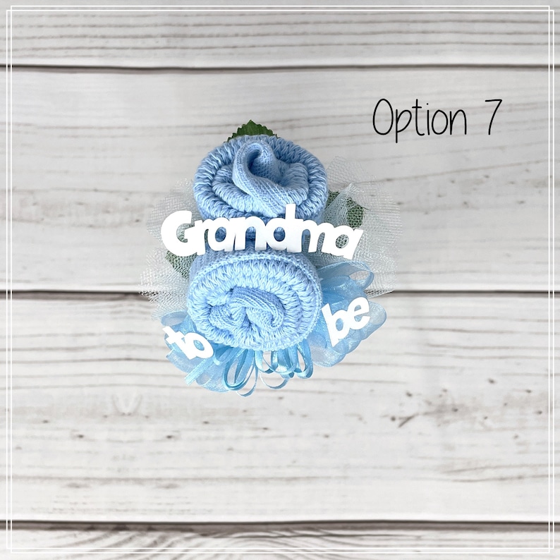 May include: A blue sock flower bouquet with white text that reads "Grandma to be".