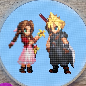 May include: Cross-stitch embroidery of two video game characters on a light blue background, set in a wooden embroidery hoop. The characters are pixelated, with one in a pink dress and the other in black armor. Gold scissors, embroidery floss, and purple orchids surround the hoop.