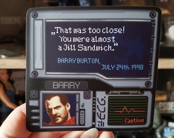 May include: A black and white sticker with a pixelated image of a video game character. The text on the sticker reads "That was too close! You were almost a Jill Sandwich." Barry Burton, July 24th 1998. The sticker also includes a pixelated image of a heart rate monitor with the word "Caution" below it.