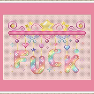 May include: Cross-stitch artwork in a pink frame. The design spells out "FUCK" in rainbow hues, with decorative elements above and below. The background is a light pink fabric, typical of cross-stitch.