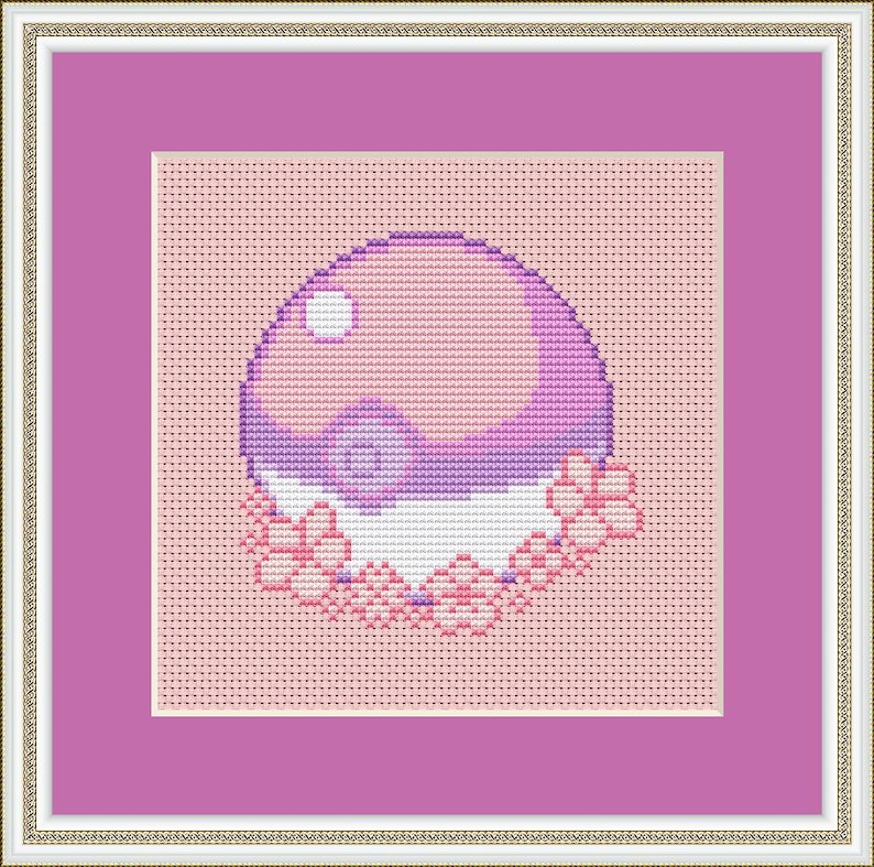May include: A purple and pink cross-stitch design of a bubble with a white center and pink flowers around it.