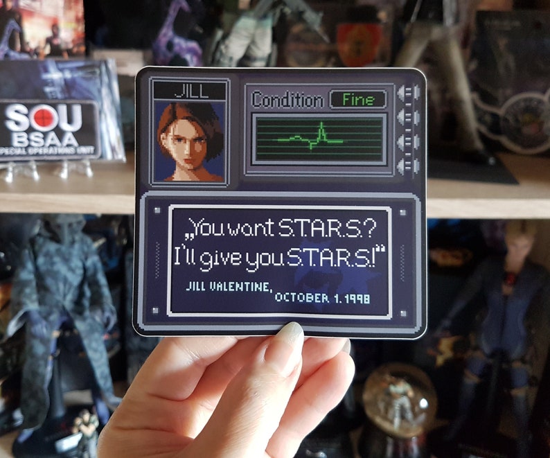 May include: A black and white pixelated sticker featuring a character from the video game Resident Evil. The sticker has a quote from the game: "You want STAR.S? I'll give you STARS!"  Jill Valentine, October 1, 1998.