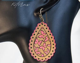 May include: Pink wooden teardrop-shaped earrings with a scalloped edge and a design of pink butterflies.