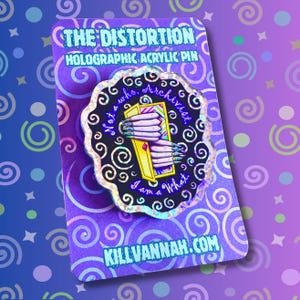 May include: A holographic acrylic pin with the text "THE DISTORTION" and "HOLOGRAPHIC ACRYLIC PIN". The pin features a black and silver design with the words "Not a who, Archivist, I am a What." and a yellow card held by hands.