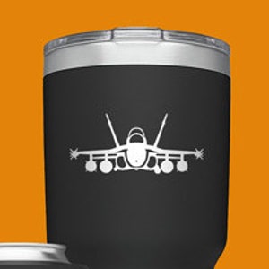 May include: Four different sizes of YETI tumblers with a silhouette of a fighter jet printed on each. The tumblers are in black, blue, green, and white.