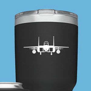 May include: Three different sizes of YETI tumblers with a white silhouette of an F-15 Eagle fighter jet on each. The tumblers are black, green, and blue.