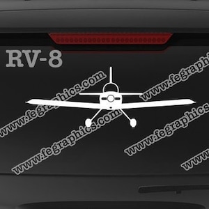 May include: A white RV-8 airplane decal on a black car with the text "www.fegraphics.com" and "Flight Engineered Graphics". The decal is next to a Veteran Owned Business logo.