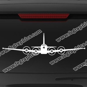 May include: White aircraft decals on a black vehicle window. The decals feature a detailed airplane design. The image also includes a blue rectangle with the text "www.fegraphics.com Flight Engineered Graphics Aircraft Decals Veteran Owned Business".