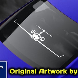 May include: A white vinyl decal of a small private jet on a blue car. The decal is on the back window of the car. The text "www.fegraphics.com Flight Engineered Graphics Aircraft Decals Original Artwork by NATE" is on the car. The text "Every Decal is Hand Made to order by me, NATE." is below the car.