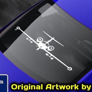 May include: White X-wing fighter decal on a blue car window. The decal is a detailed graphic of the iconic starfighter from the Star Wars franchise. The image also includes text: "Original Artwork by NATE" and "Aircraft Decals".