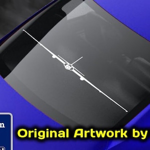 May include: A white decal of a B-52 bomber aircraft on the back window of a blue car. The decal is from Flight Engineered Graphics, a veteran owned business. The text "Original Artwork by NATE" is visible in the image.