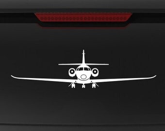 May include: A black SUV with a white "Veteran Owned Business" sticker on the back window. The sticker features a small American flag. There are two white silhouette decals of airplanes on the back window.