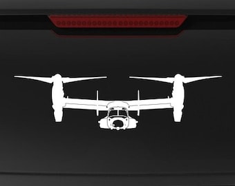 Könnte beinhalten: Ein schwarzer SUV mit einer weißen Silhouette eines V-22 Osprey-Flugzeugs auf der Heckscheibe. Das Fahrzeug hat einen "Veteran Owned Business"-Aufkleber am hinteren Stoßfänger.