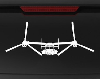 Könnte beinhalten: Ein schwarzer SUV mit einer weißen Silhouette eines V-22 Osprey-Flugzeugs auf der Heckscheibe. Das Fahrzeug hat einen "Veteran Owned Business"-Aufkleber am hinteren Stoßfänger.