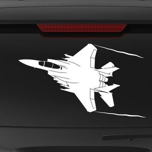 May include: A black SUV with a white silhouette of two fighter jets on the back window. The vehicle has a "Veteran Owned Business" sticker on the back bumper.
