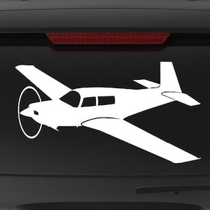 May include: A black SUV with a white silhouette of a small plane on the back window. The car has a "Veteran Owned Business" sticker on the back bumper.