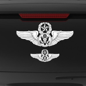 May include: A black SUV with a white "Veteran Owned Business" sticker on the back window. The sticker features a small American flag and the words "Veteran Owned Business". There is also a white Air Force wings decal on the back window.