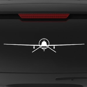 May include: A black SUV with a white silhouette of a plane on the back window. The car has a "Veteran Owned Business" sticker on the back bumper.