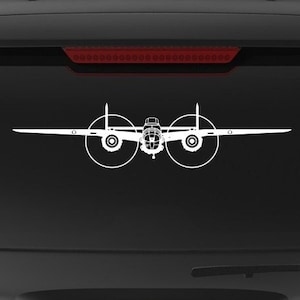 May include: A black SUV with a "Veteran Owned Business" sticker on the back. The sticker features a red, white, and blue American flag. There are two white silhouette decals of airplanes on the back window.