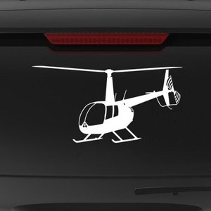 May include: A black SUV with a white silhouette of a helicopter on the back window. The vehicle has a "Veteran Owned Business" sticker on the back bumper.