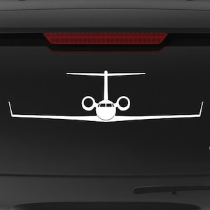 May include: A black SUV with a white decal of a private jet on the back window. The decal says "Veteran Owned Business" and "fegraphics.com".