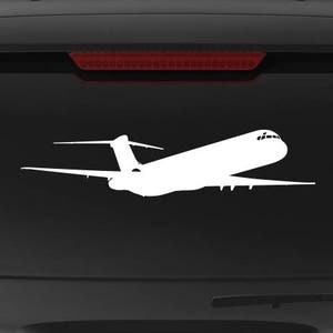 May include: A black SUV with a white silhouette of an airplane on the back window. The car has a "Veteran Owned Business" sticker on the back bumper.