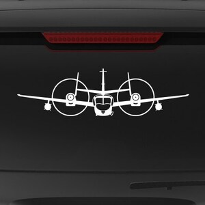 May include: A black SUV with a "Veteran Owned Business" sticker on the back window. The sticker features a red, white, and blue American flag. There are two white silhouette decals of airplanes on the back window.