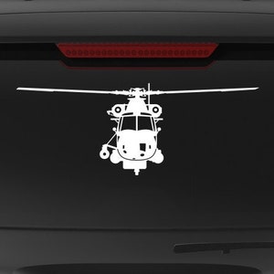 May include: A black SUV with a white silhouette of a helicopter on the back window. The vehicle has a "Veteran Owned Business" sticker on the back bumper.