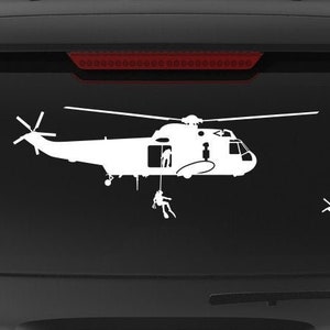 May include: A black SUV with a white silhouette of a helicopter and the text "Veteran Owned Business" on the back.