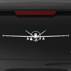 May include: A black SUV with a white silhouette of a drone on the back window. The vehicle has a "Veteran Owned Business" sticker with an American flag on the back bumper.