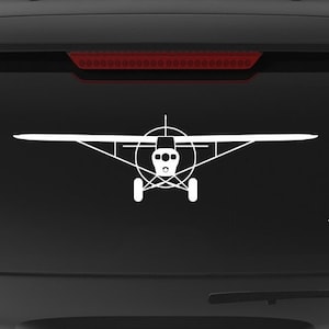 May include: A black SUV with a white silhouette of a small plane on the back window. The car has a "Veteran Owned Business" sticker on the back bumper.
